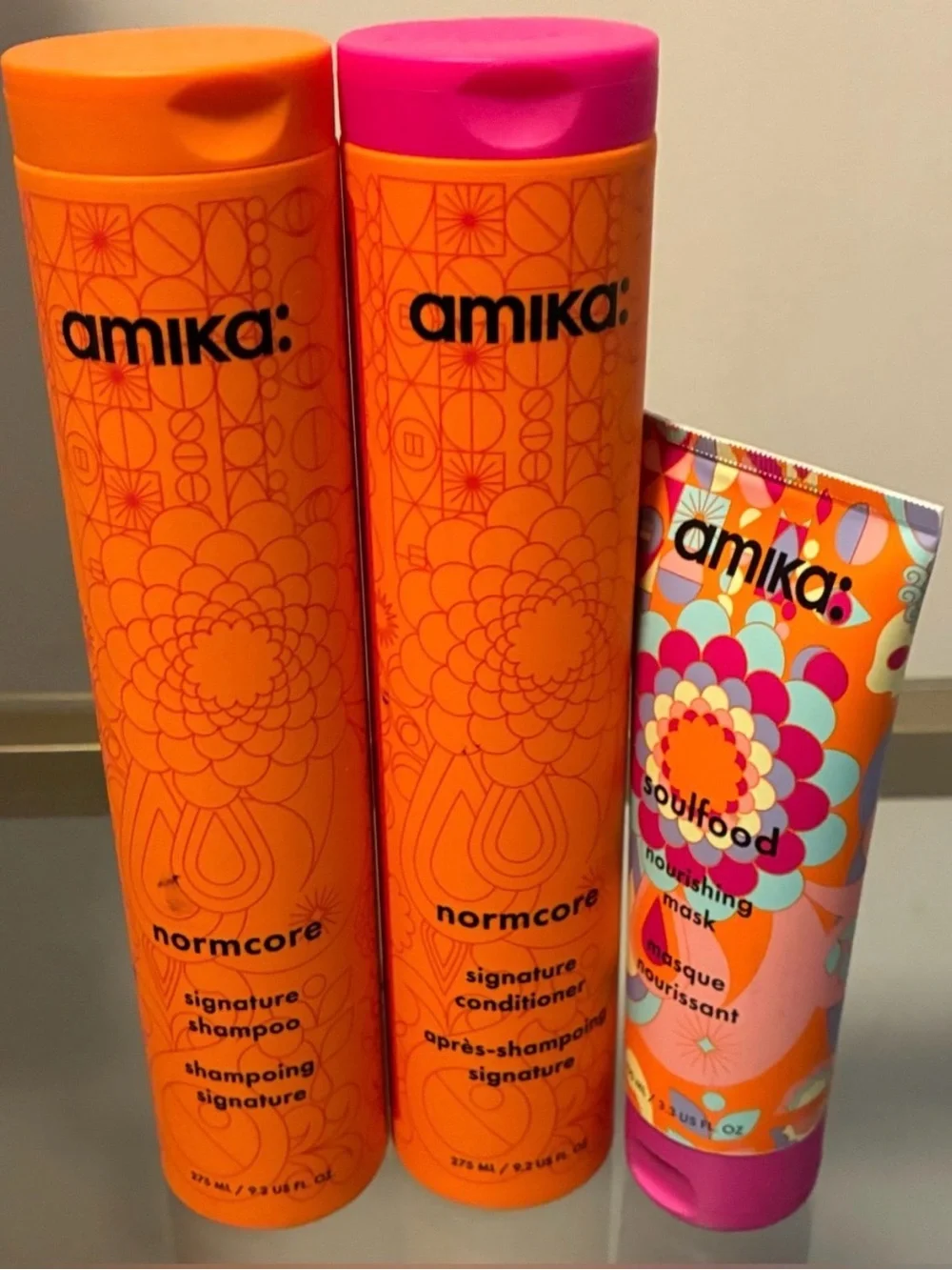 amika Orange Haircare Bottles with Pink Accent